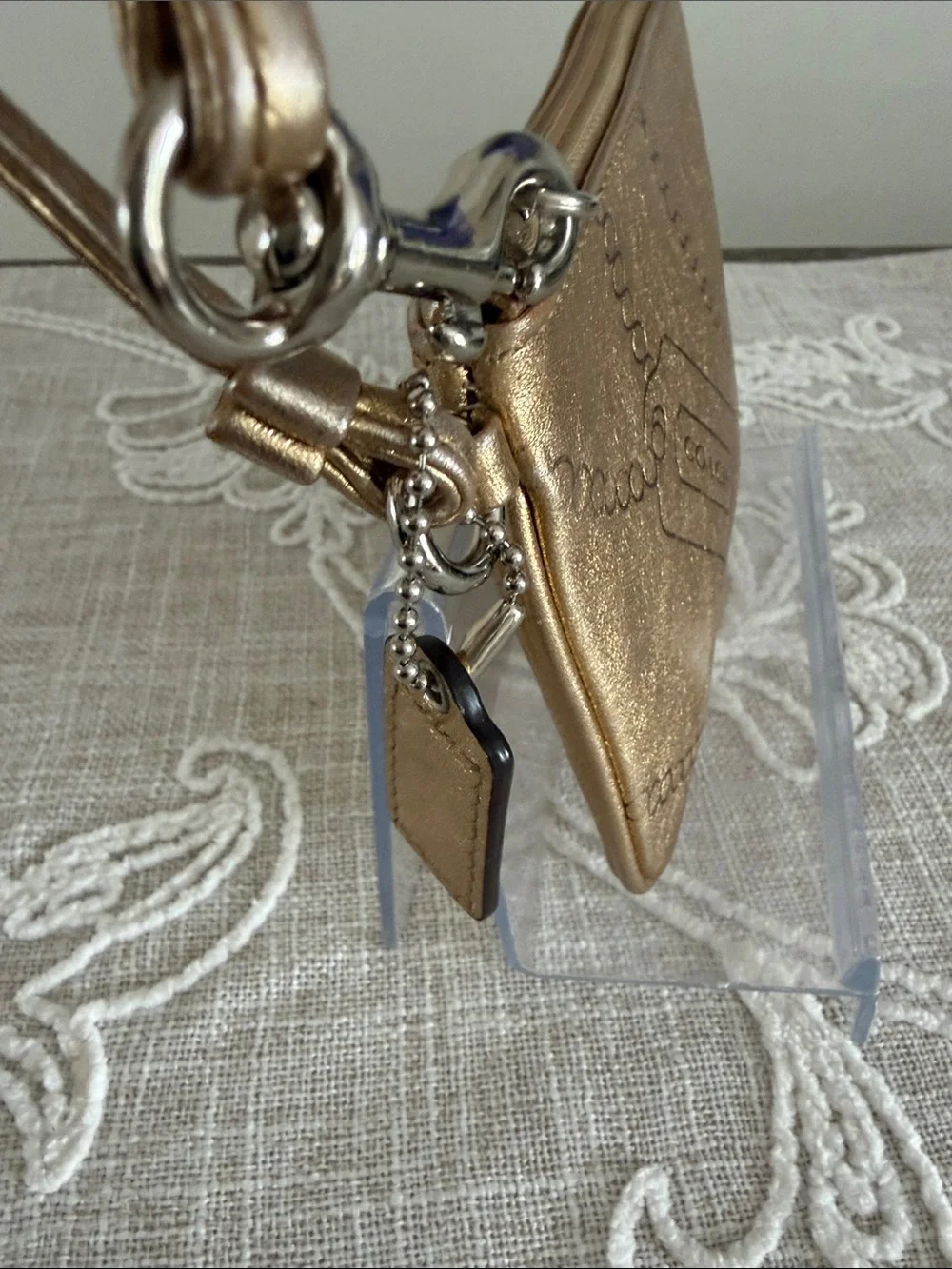 Coach Metallic Gold Wristlet with Embossed Chain Motif